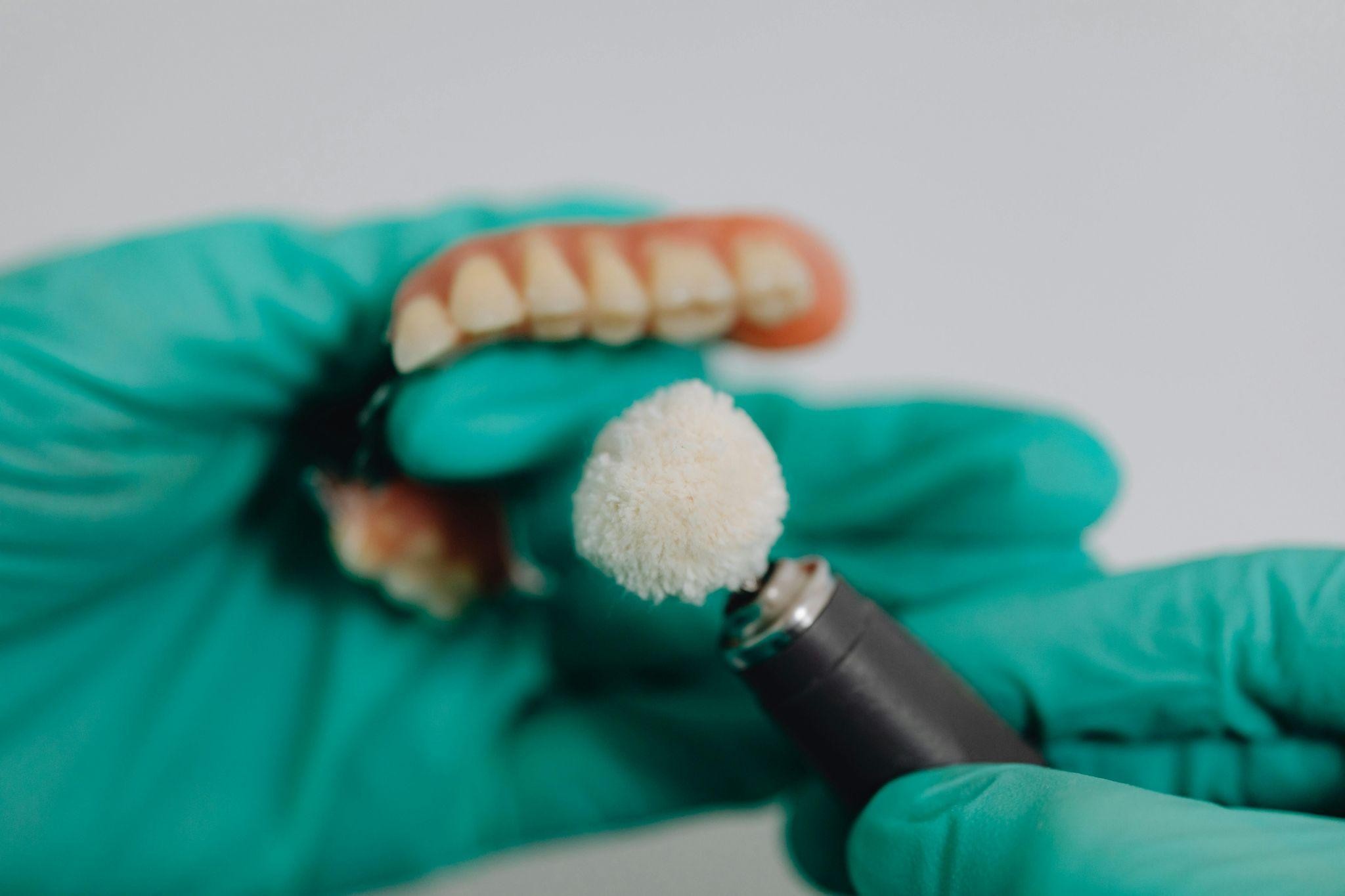 Do you have missing or damaged teeth? Are you wondering about your options for restoring your smile? Dental implants and dentures are excellent options that can significantly enhance your appearance and confidence. Missing or damaged teeth aren’t a medical emergency, but they impact most areas of your life. When you look in the mirror and see gaps or cracks in your teeth, it affects how you feel about your appearance. Missing teeth also impact your ability to chew and speak, and your overall dental health. Over time, untreated gaps can lead to bone loss, shifting teeth, and even gum disease. You may be able to continue with your usual daily activities despite missing or damaged teeth, but over time, the cumulative impact of the situation becomes noticeable. Eating becomes more difficult, certain words may be harder to pronounce, and your smile may not reflect how you truly feel inside. The good news is that you have options if you’re tired of not loving what you see when you smile at a mirror or are concerned that missing teeth could lead to worse dental issues. The two most common solutions are dental implants and dentures, both of which are highly effective, depending on your individual needs. How do you know which of the two most popular options is right for you? Dental Implants Dental implants are a permanent solution for missing teeth. Both partial and full implants are available and anchored securely into your jawbone for maximum stability. People love implants because they are durable, preserve the jawbone, and have a natural look and feel. Implants function and feel like natural teeth, making them ideal for individuals seeking a seamless, long-lasting solution. Once your implants are placed and your mouth has healed, your teeth function just as well, if not better, than your original, natural teeth. Implants don’t shift or slip, allowing you to eat, speak, and smile confidently. Implants are surgically installed, so there are some minor risks involved, and you’ll have a short recovery period before you can return completely to normal. Most implant recipients agree, however, that the drawbacks are worth the trade-off, as they ultimately end up with a set of teeth that look and feel like their natural teeth. Dentures Dentures are a tried-and-true option for replacing damaged or broken teeth. Like implants, they can be full or partial, and modern designs are more comfortable and natural-looking than ever. In comparison to implants, dentures require no healing or recovery period, and they are non-surgical. They also cost less than implants. Dentures are often the best option for many people, especially when seeking a quicker or more affordable solution. However, because dentures are removable, you cannot treat them like your regular teeth. You remove them for cleaning, and most people avoid certain foods when they have dentures. They might also not be as durable as implants. Some people experience a learning curve when adjusting to speaking and eating with dentures, but most adapt over time. How Do You Choose? Your dentist will discuss the pros and cons of each option with you. In some cases, a patient might not have a choice due to their health or age. Certain underlying conditions may make surgery inadvisable, while others may make dentures less stable or comfortable. If both options are available, you’ll want to consider the following when making your choice: • Age • Oral health • Overall health • Budget • Lifestyle Some patients even choose a combination—using implants to anchor dentures for added stability. How We Can Help The experienced team at Guelph Village Dental can guide you toward the best choice for replacing or repairing your teeth and restoring your smile. We utilize advanced technology and a patient-centred approach to help you feel confident that you’re making the right choice. We want you to feel as comfortable and confident as possible with your choice. During your first visit, we’ll do a consultation and discuss your options for tooth replacement. We’ll assess your dental health and ensure you understand the risks and benefits of implants and dentures. We’ll also address any questions you have so that you can make an informed decision. If you’re ready to love your smile again, give us a call to schedule a consultation. We’re here to help you smile with confidence every day.